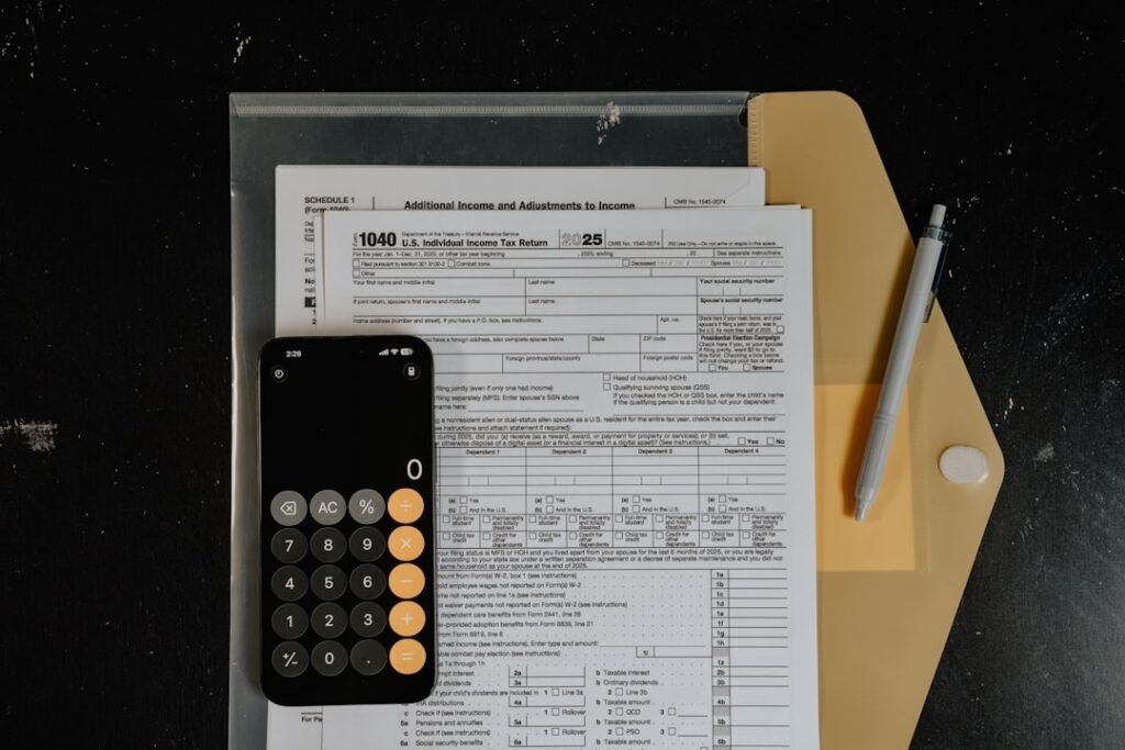 Calculator and pen on tax forms